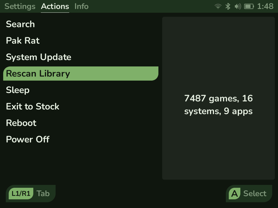 The System page on its Actions tab, with Settings, Actions, and Info tabs across the top, a list of actions like Search, Pak Rat, System Update, and Rescan Library, and a live count of games, systems, and apps